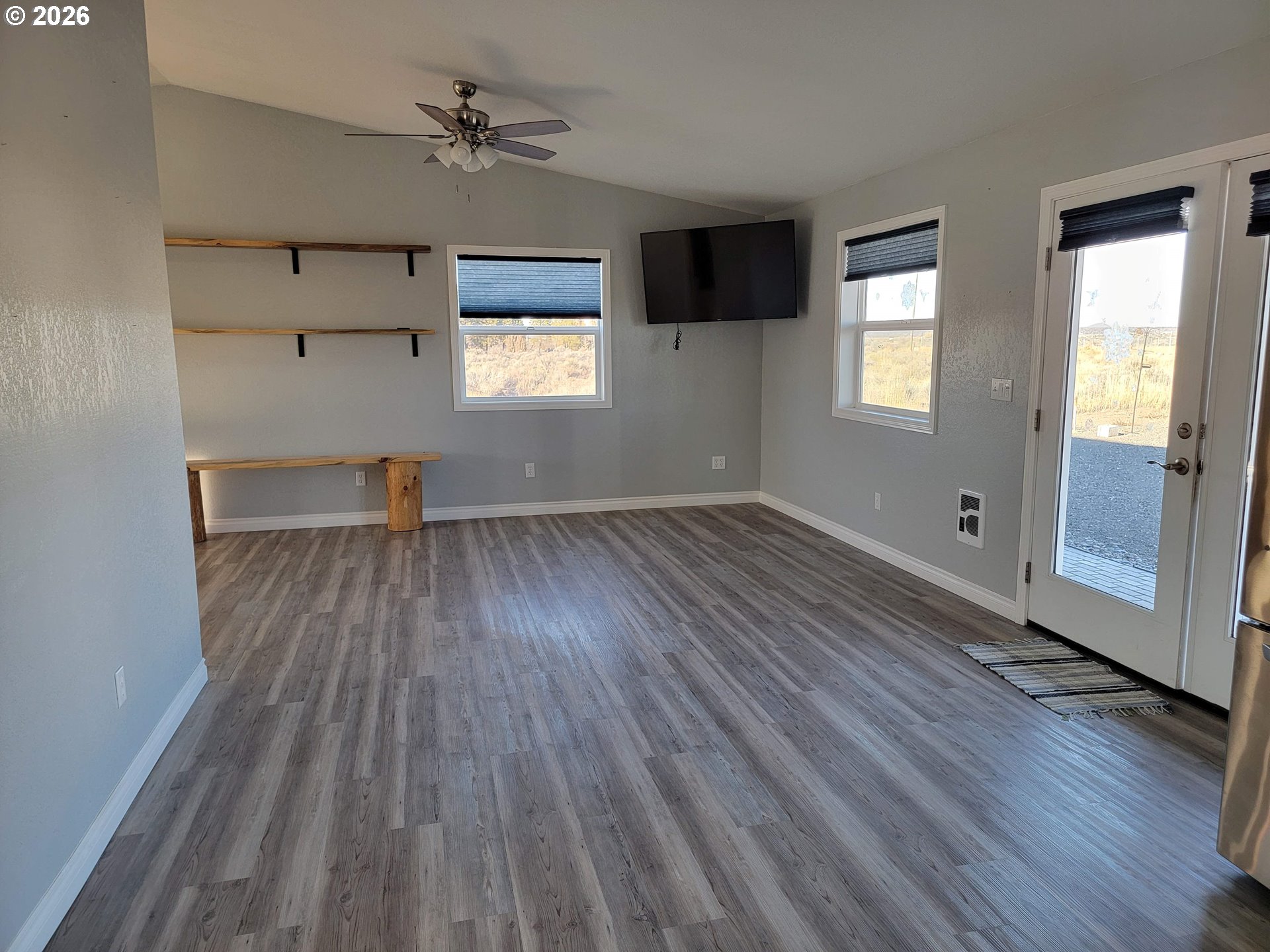 58098 Maple Circle Road Christmas Valley, OR 97641 - Photo 11 of 33 an empty room with wooden floor and windows