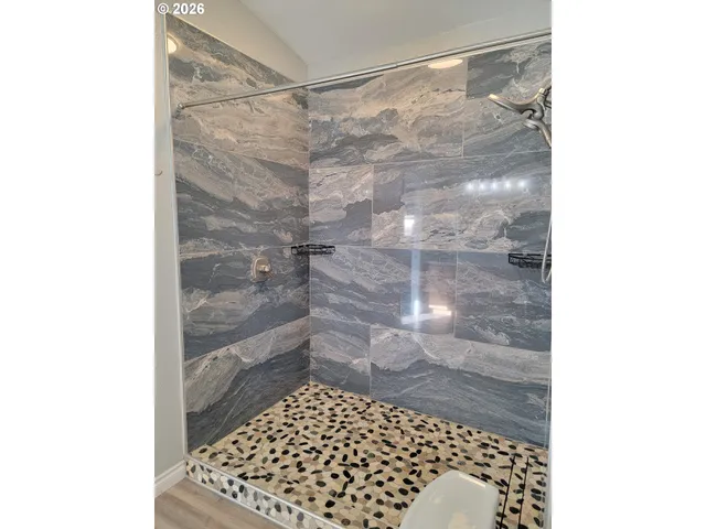 a bathroom with a toilet and a shower