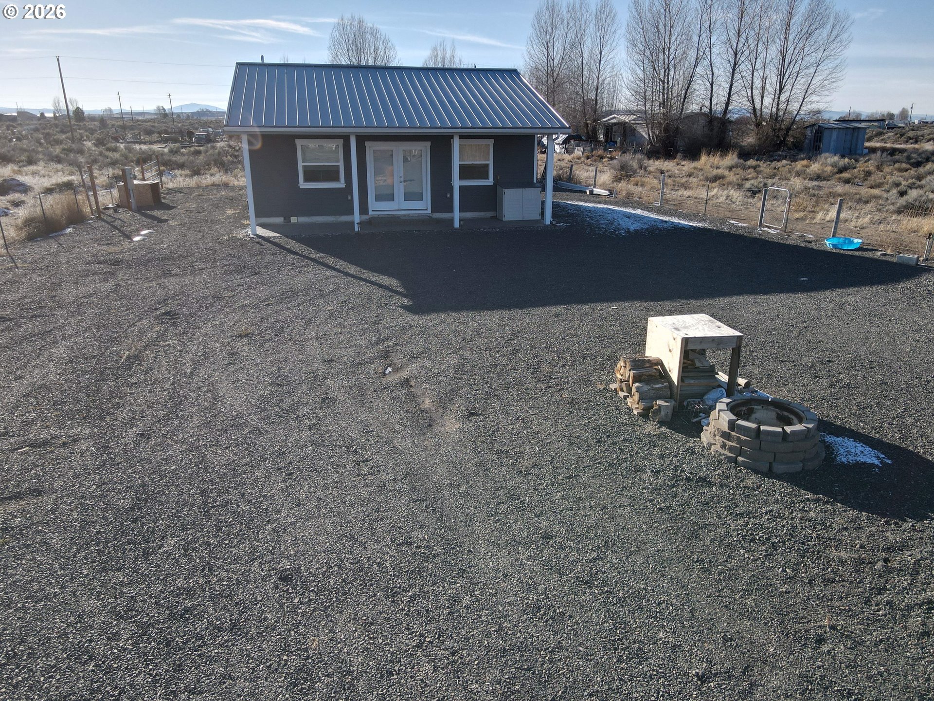 58098 Maple Circle Road Christmas Valley, OR 97641 - Photo 2 of 33 a front view of a house with garden