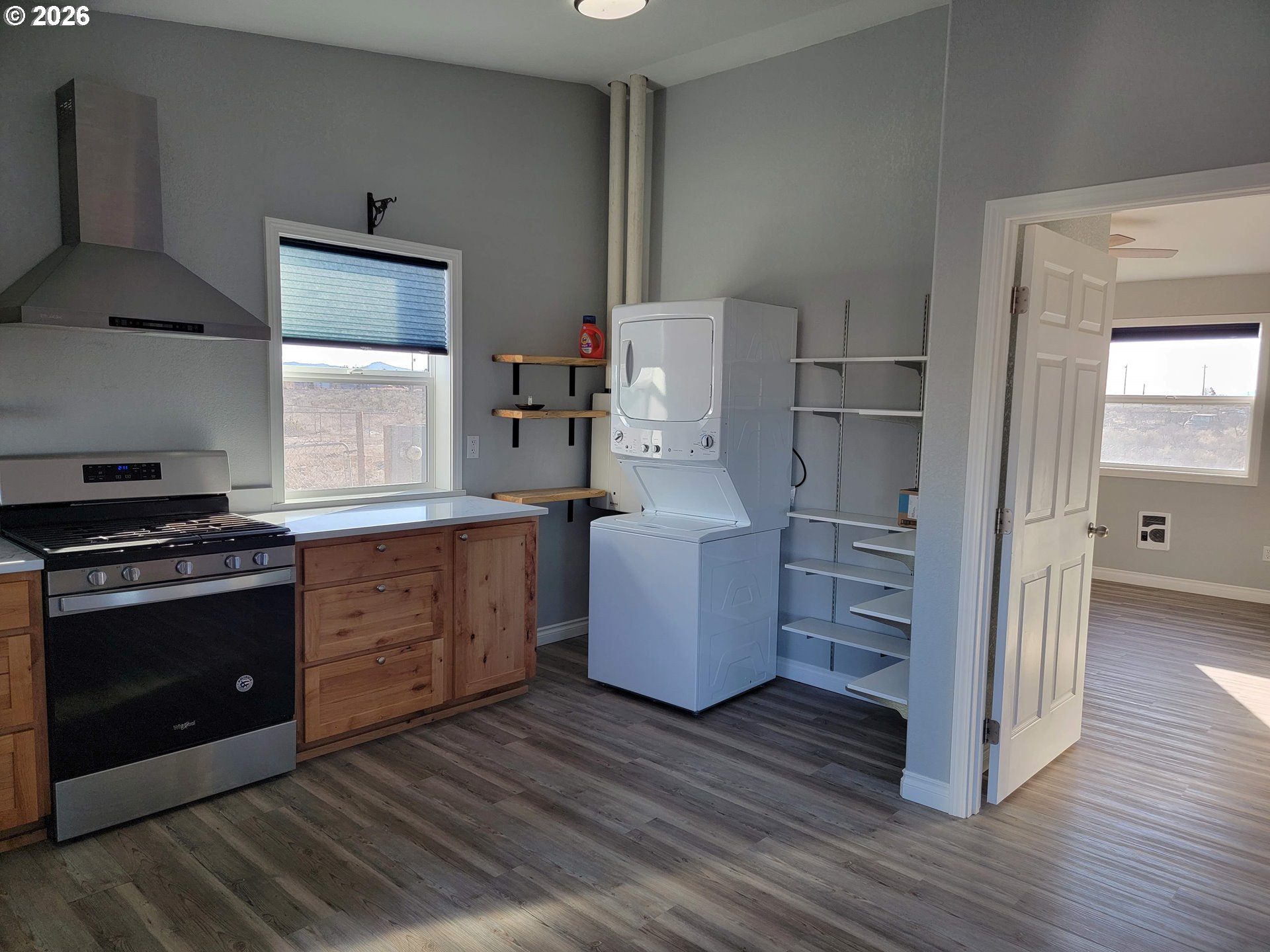 58098 Maple Circle Road Christmas Valley, OR 97641 - Photo 6 of 33 a kitchen with granite countertop a refrigerator and a stove top oven