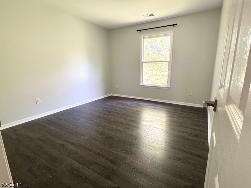 76 Jamestown Road Bernards, NJ 07920 - Photo 8 of 20 an empty room with wooden floor and windows
