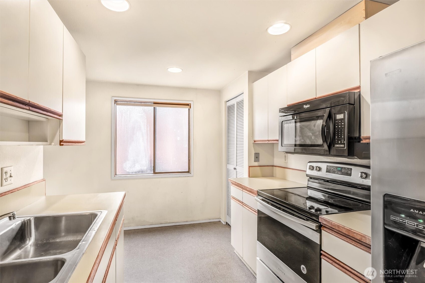 505 West Roy Street, Unit 304 Seattle, WA 98119 - Photo 12 of 33 a kitchen with stainless steel appliances a stove a sink and a microwave
