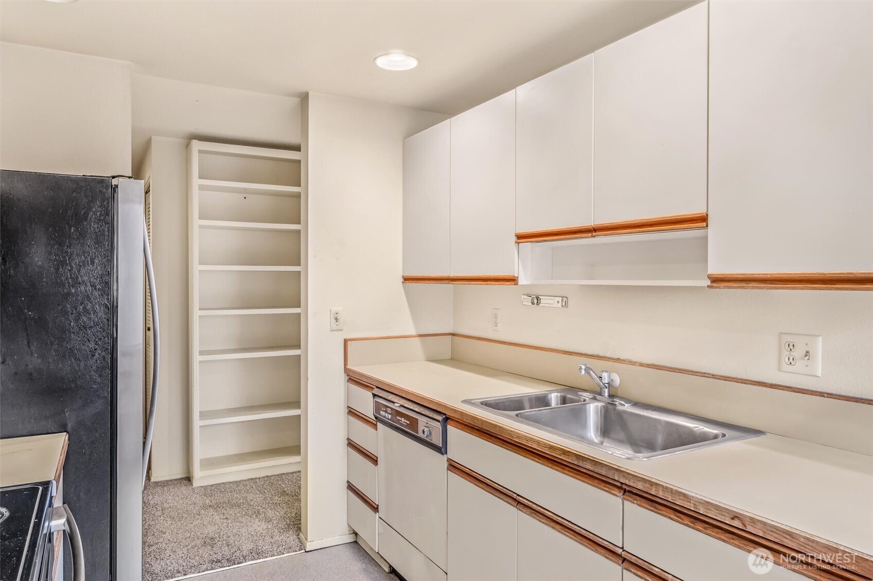 505 West Roy Street, Unit 304 Seattle, WA 98119 - Photo 13 of 33 a kitchen with a sink and a refrigerator