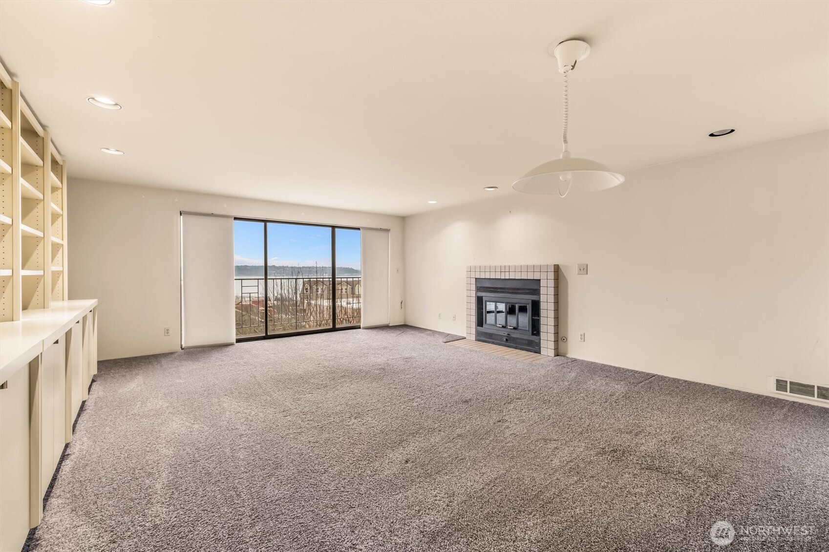 505 West Roy Street, Unit 304 Seattle, WA 98119 - Photo 3 of 33 a view of an empty room with a fireplace and a window