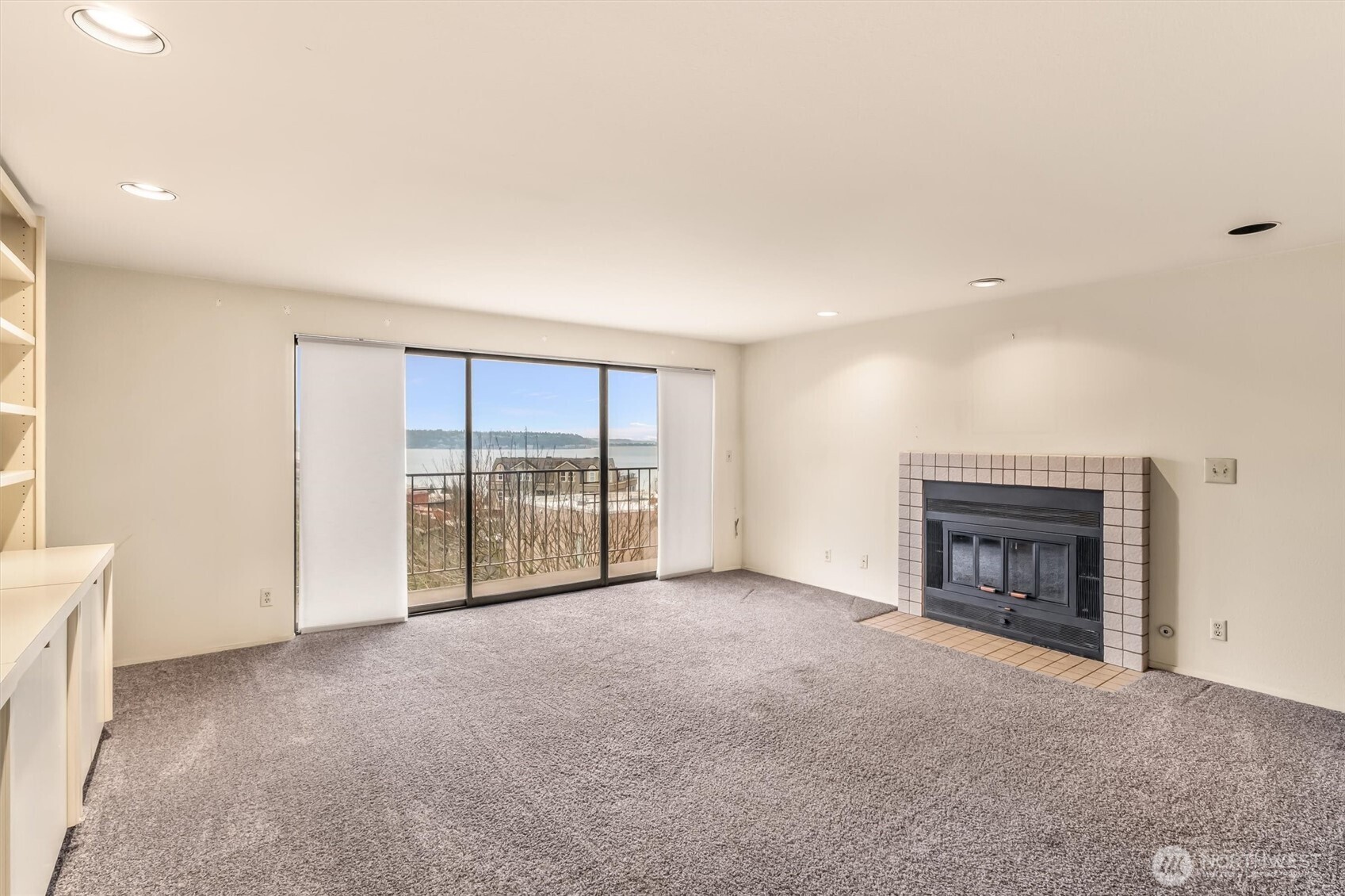 505 West Roy Street, Unit 304 Seattle, WA 98119 - Photo 4 of 33 an empty room with fireplace and windows