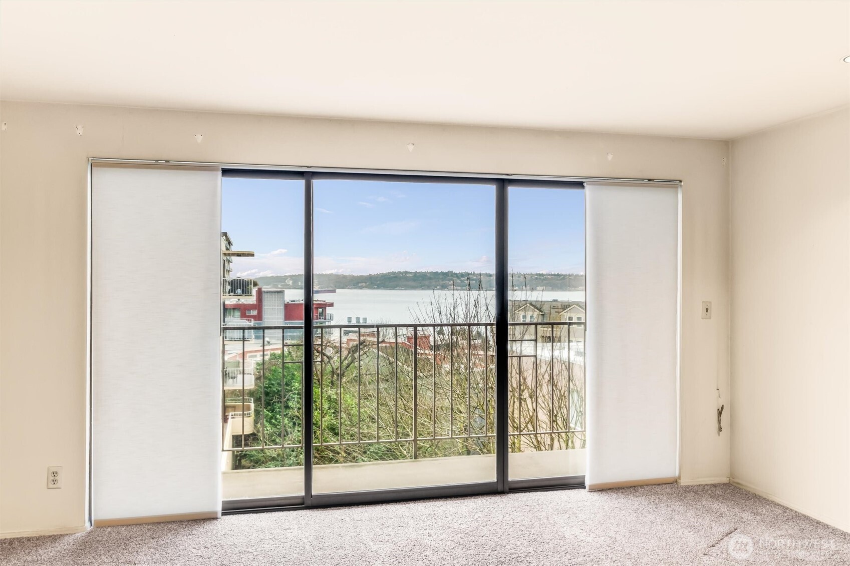 505 West Roy Street, Unit 304 Seattle, WA 98119 - Photo 5 of 33 an empty room with sliding door and mountain view