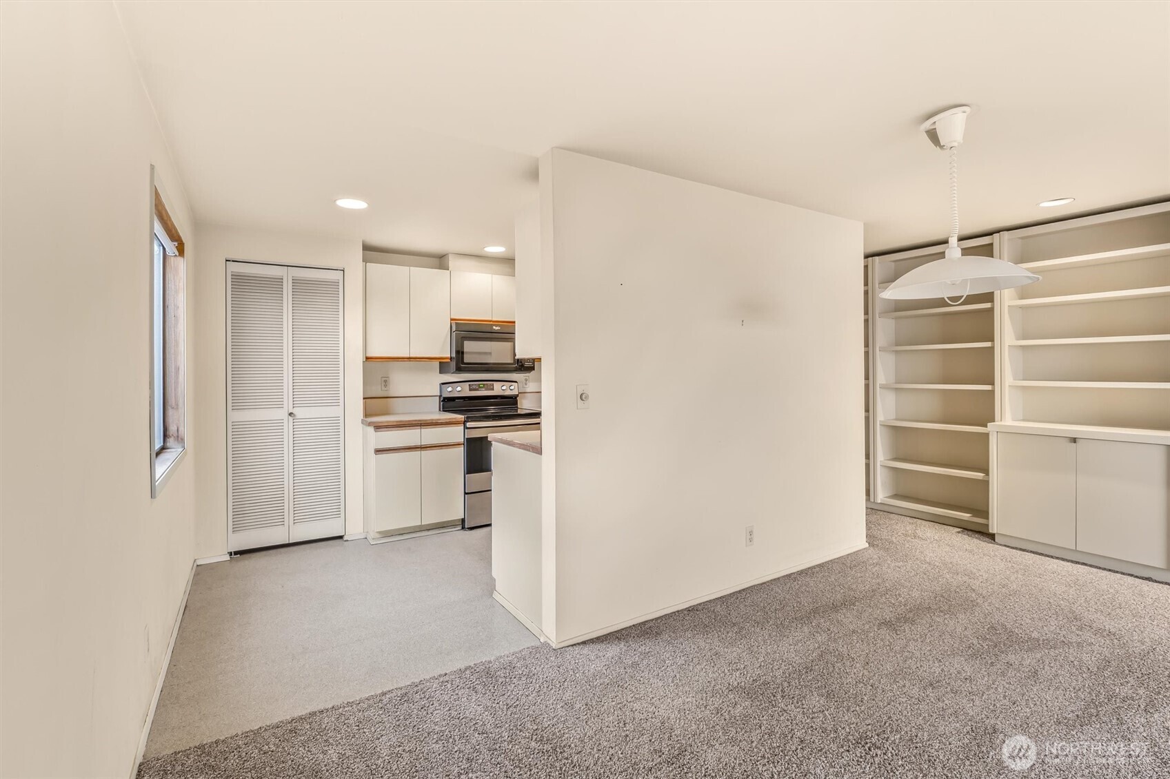 505 West Roy Street, Unit 304 Seattle, WA 98119 - Photo 10 of 33 a view of a kitchen with white cabinets and stainless steel appliances