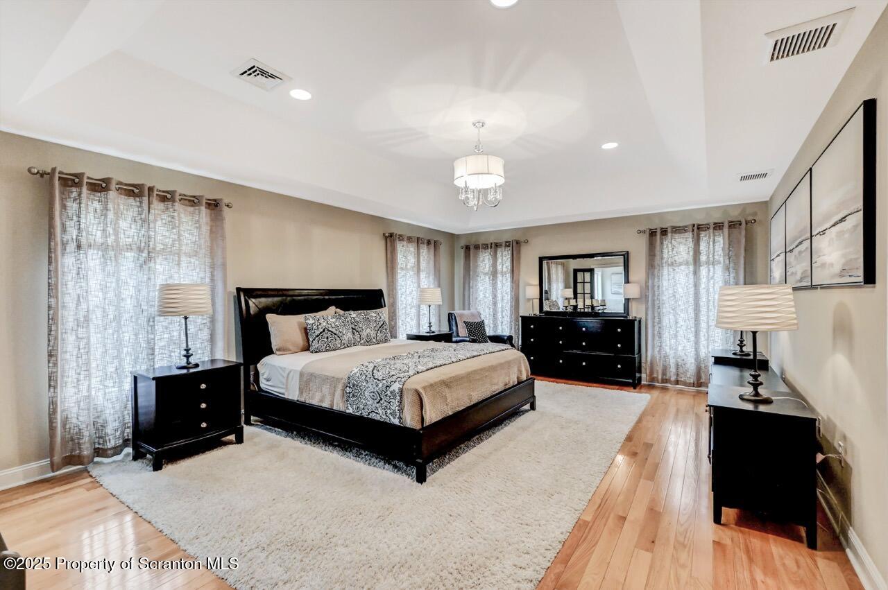 120 Highland Road Moscow, PA 18444 - Photo 41 of 84 a spacious bedroom with a bed and wooden floor