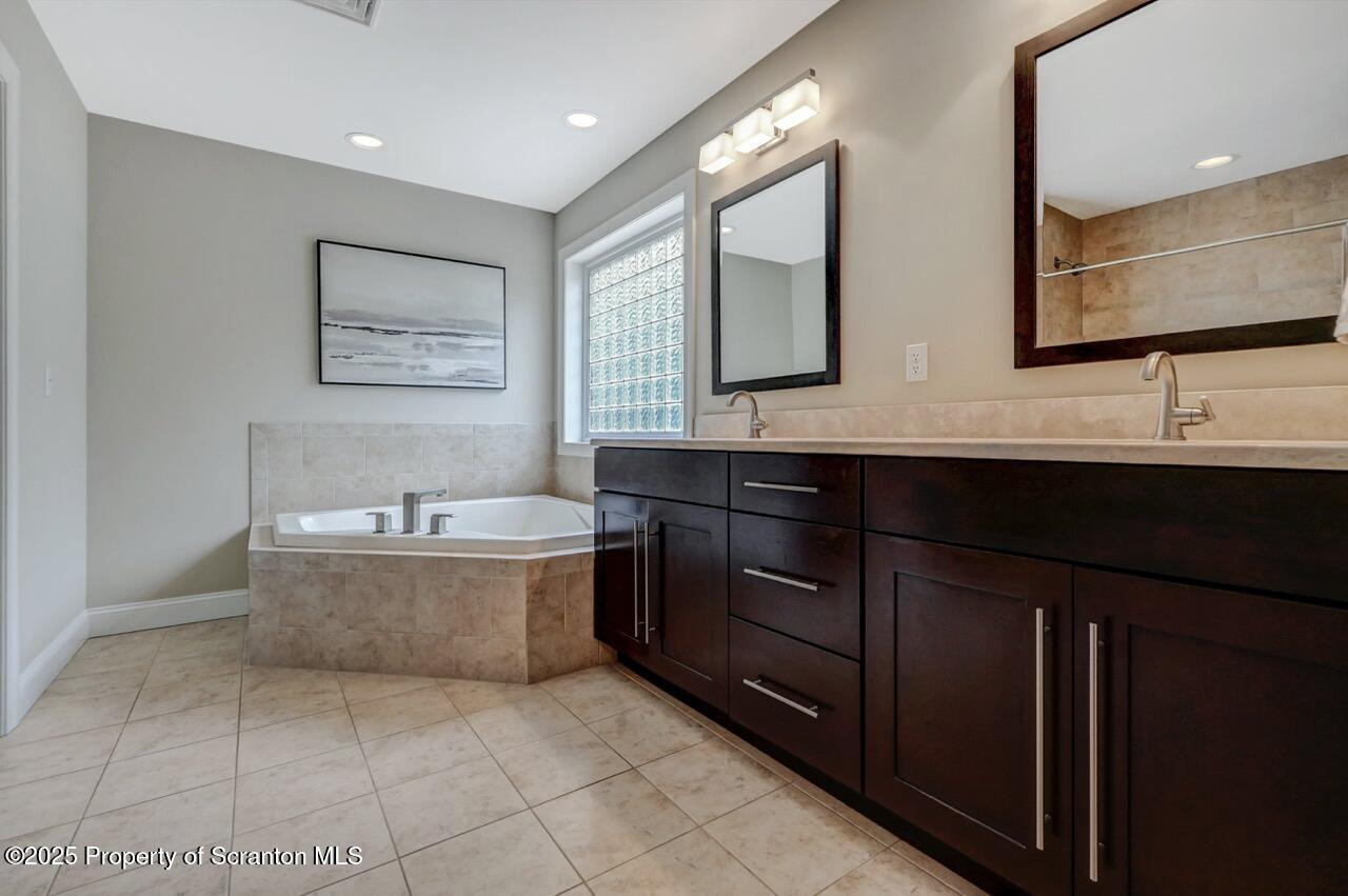 120 Highland Road Moscow, PA 18444 - Photo 45 of 84 a bathroom with a tub sink and mirror