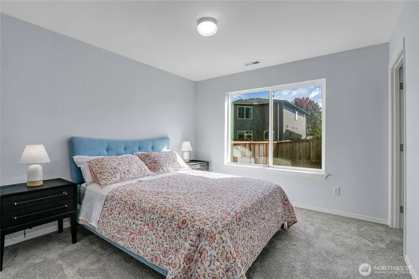 a bedroom with a bed and window