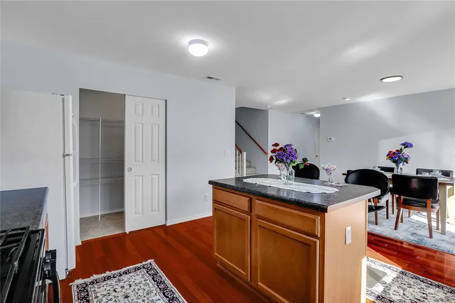 a kitchen view of a dining table chairs and utility room