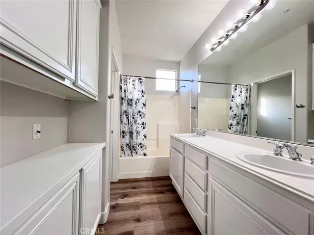 a bathroom with a sink a mirror and a shower