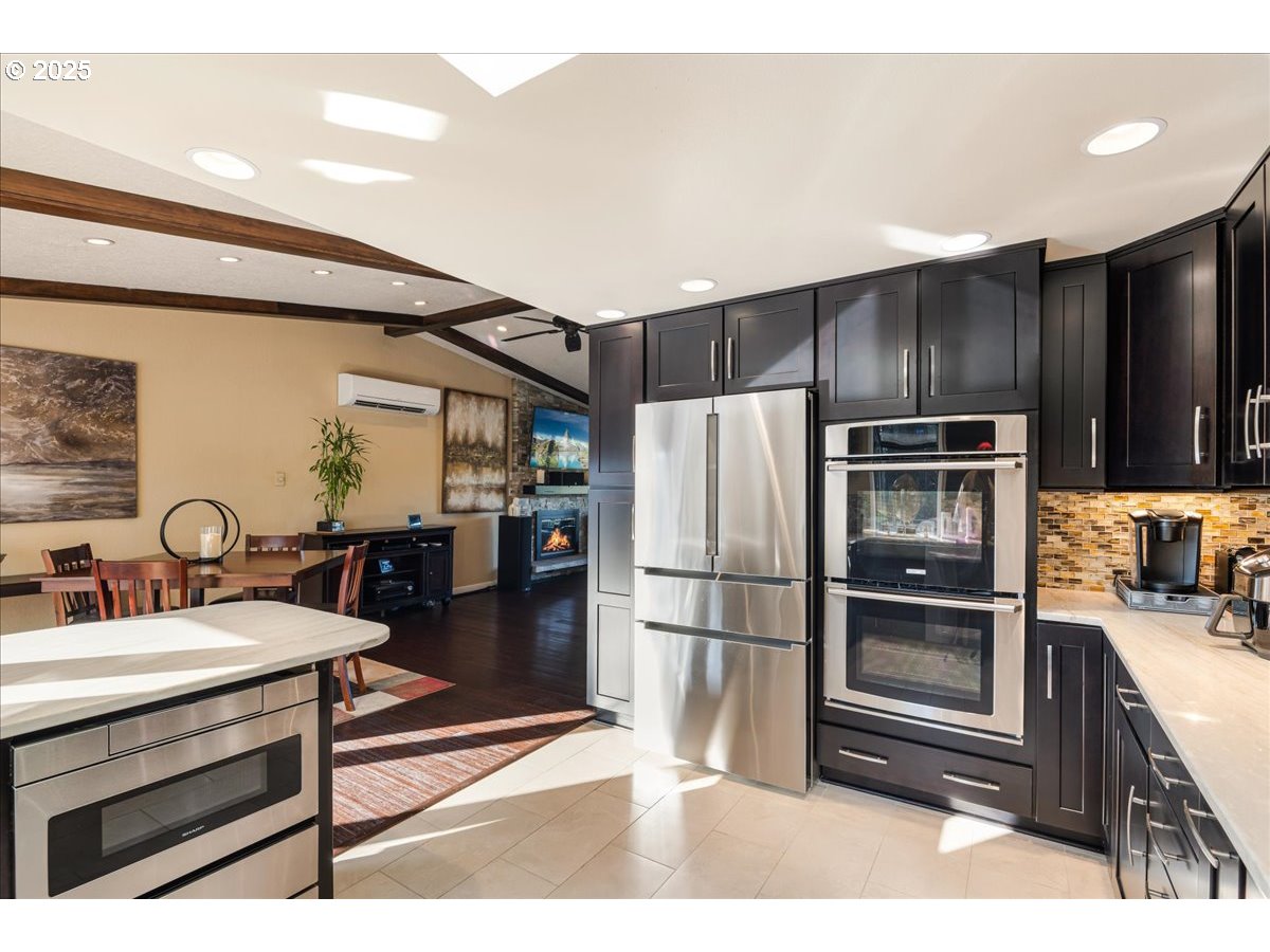 15735 Southwest 88th Avenue Portland, OR 97224 - Photo 12 of 38 a kitchen with kitchen island a counter top a sink stainless steel appliances and cabinets