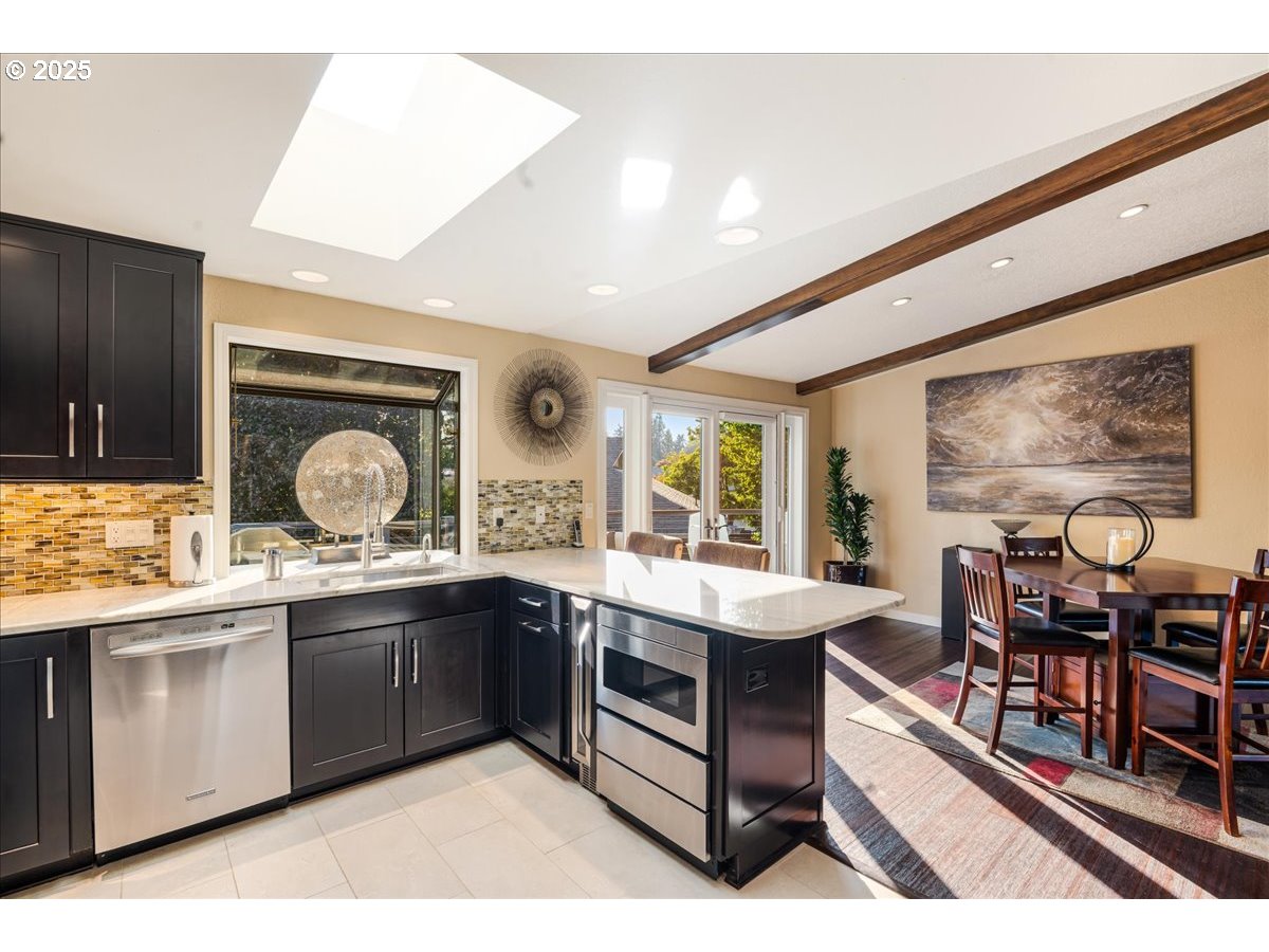 15735 Southwest 88th Avenue Portland, OR 97224 - Photo 15 of 38 a large kitchen with a counter space a sink and cabinets
