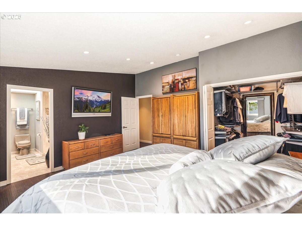 15735 Southwest 88th Avenue Portland, OR 97224 - Photo 18 of 38 a bedroom with a large bed and a flat screen tv