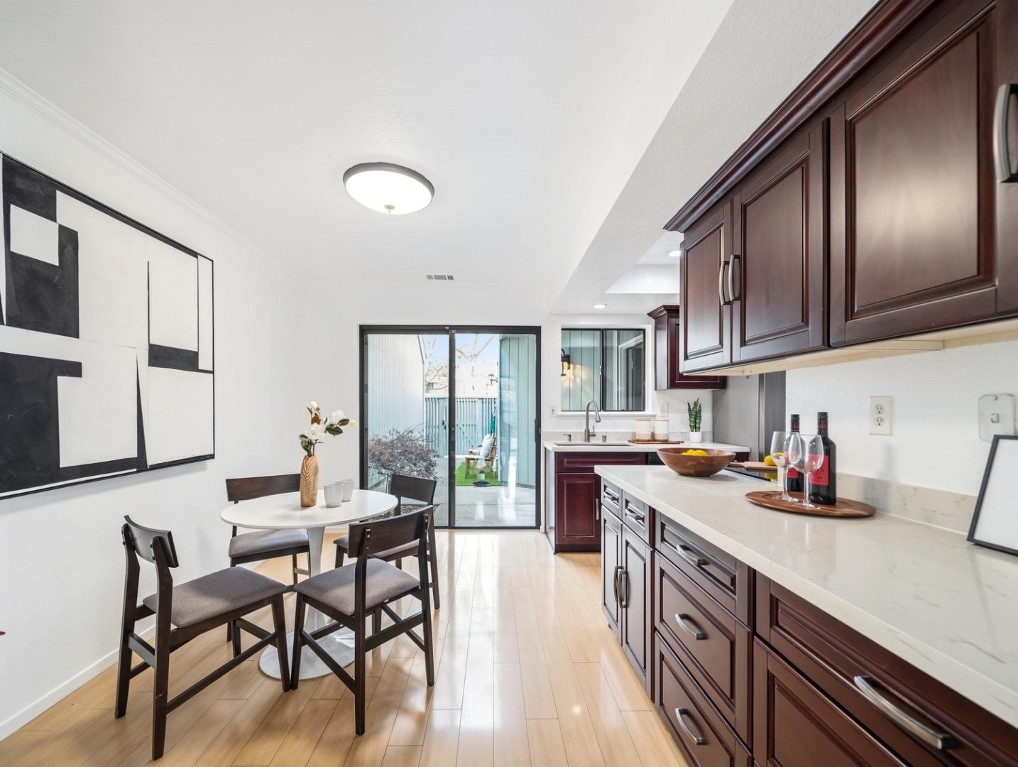 7518 Rosedale Court Pleasanton, CA 94588 - Photo 9 of 27 a kitchen with a table chairs stove and cabinets