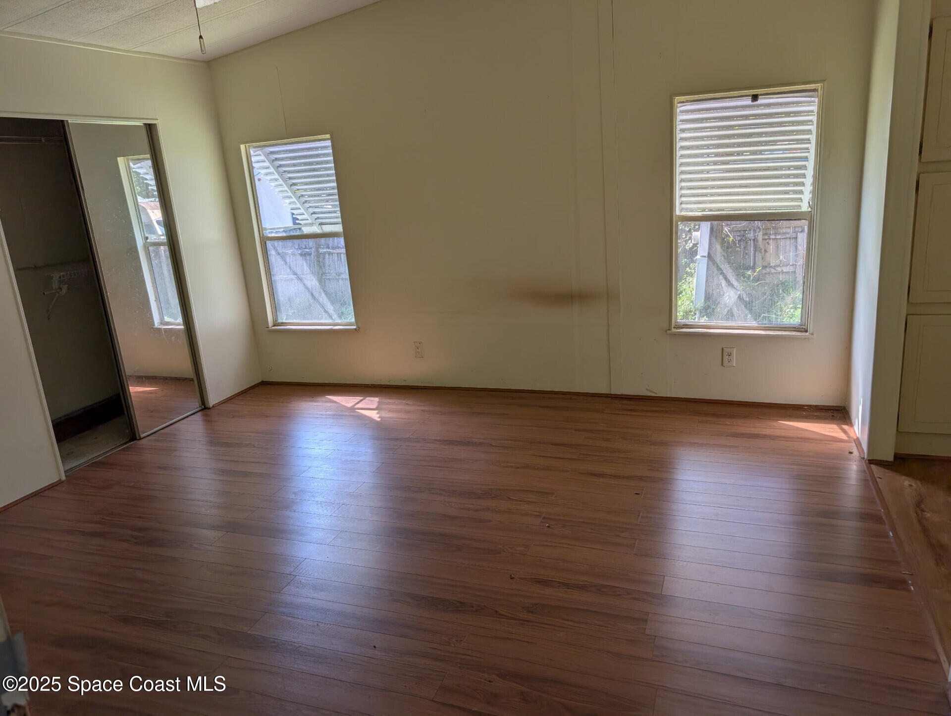 3640 Sandy Pine Place Cocoa, FL 32926 - Photo 5 of 9 an empty room with wooden floor and windows