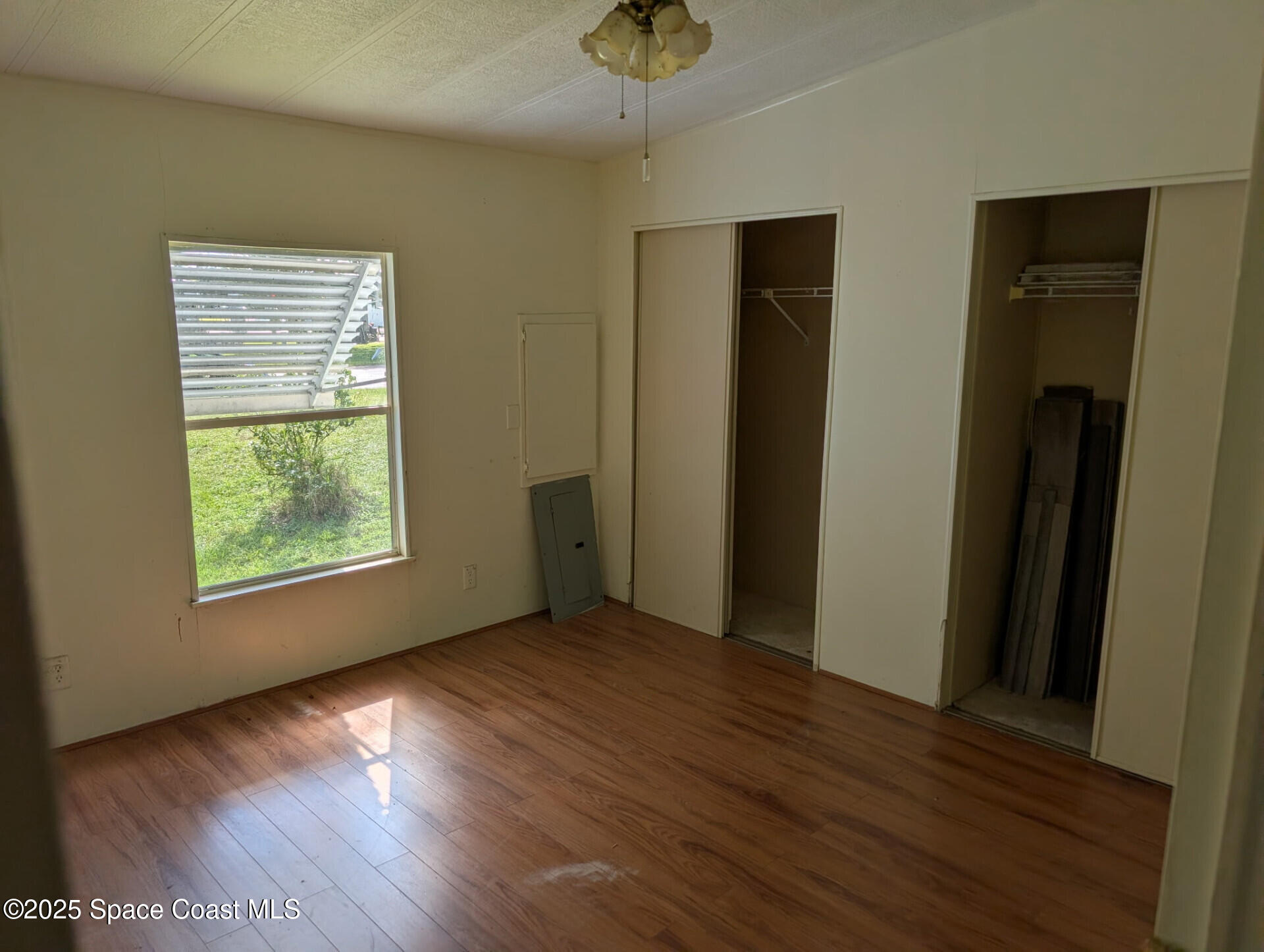 3640 Sandy Pine Place Cocoa, FL 32926 - Photo 6 of 9 a view of an empty room with wooden floor and a window