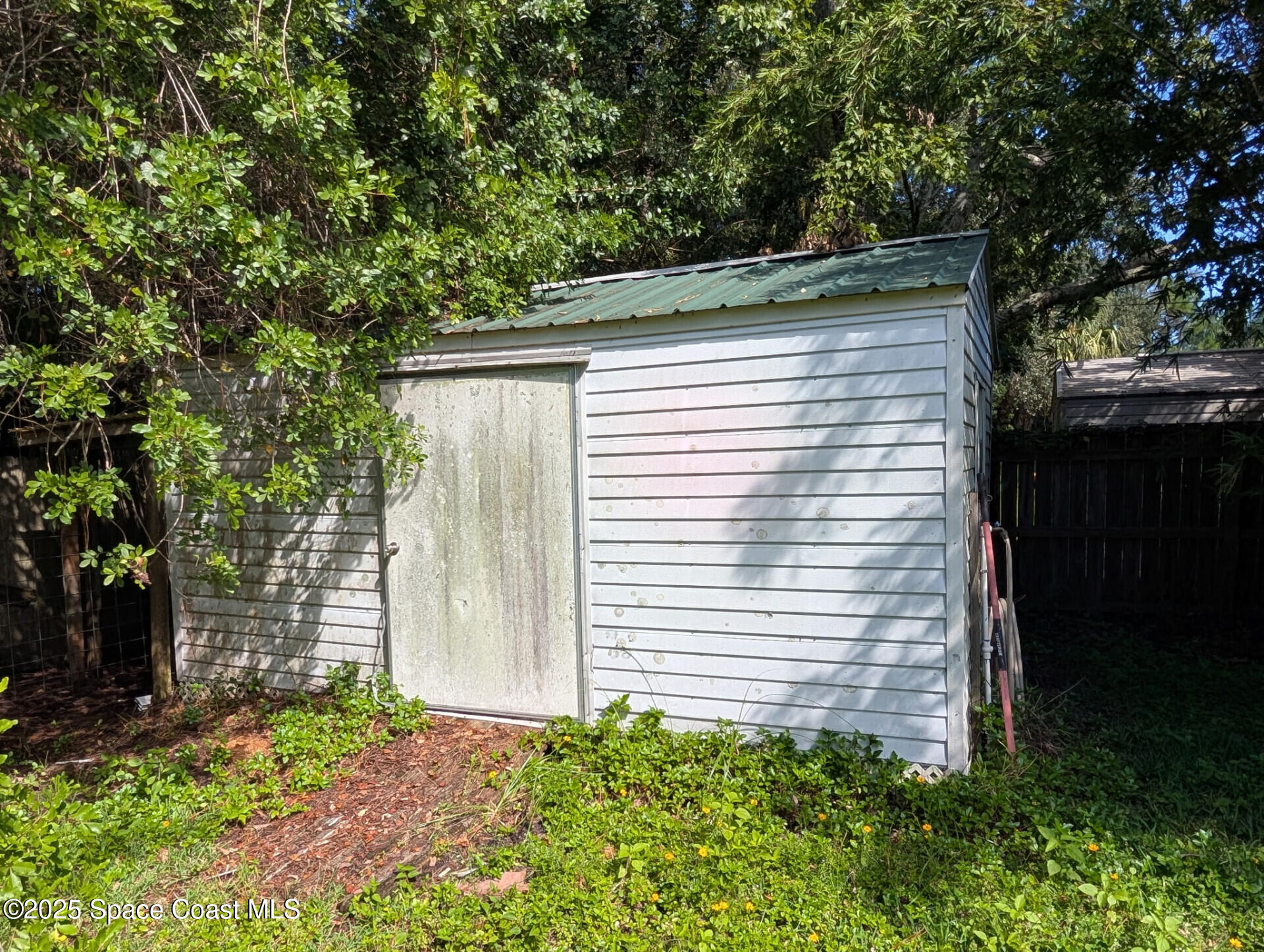 3640 Sandy Pine Place Cocoa, FL 32926 - Photo 8 of 9 a side view of a house with a yard
