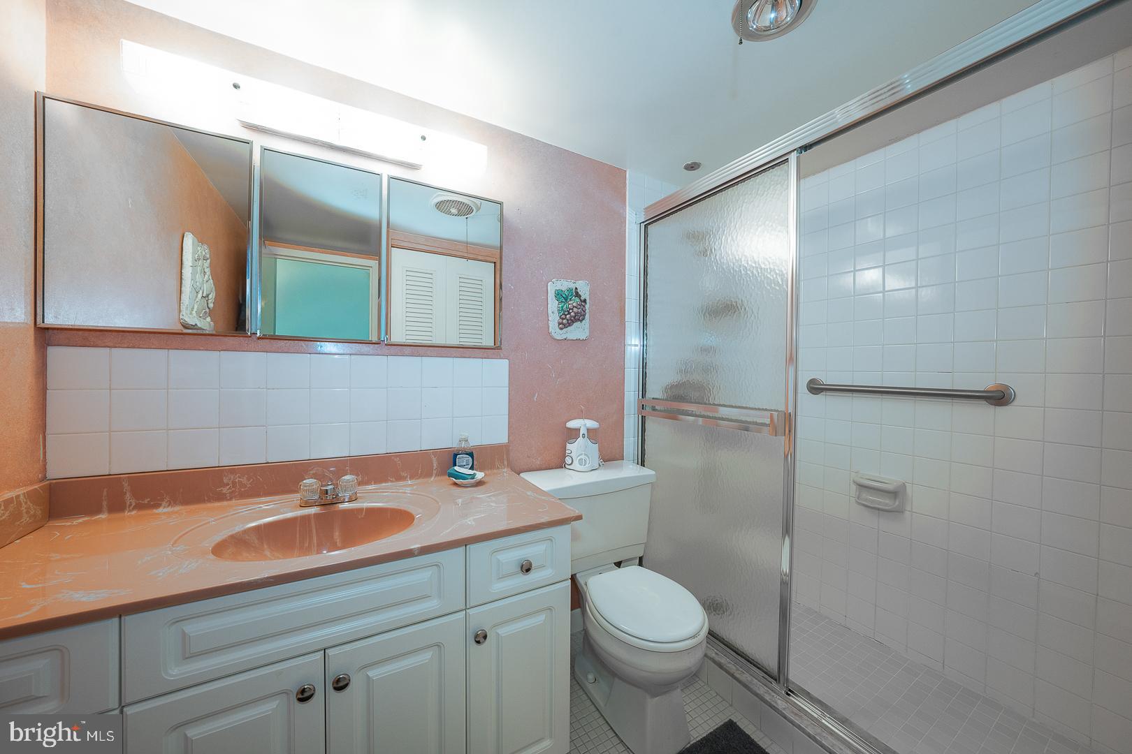 1919 Chestnut Street, Unit 1316 Philadelphia, PA 19103 - Photo 12 of 24 a bathroom with a sink a toilet and shower