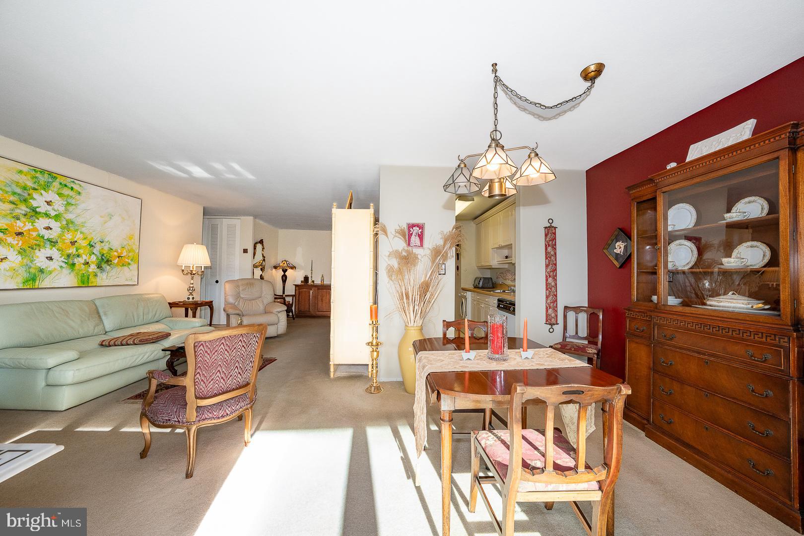1919 Chestnut Street, Unit 1316 Philadelphia, PA 19103 - Photo 4 of 24 a living room with furniture a chandelier and a dining table