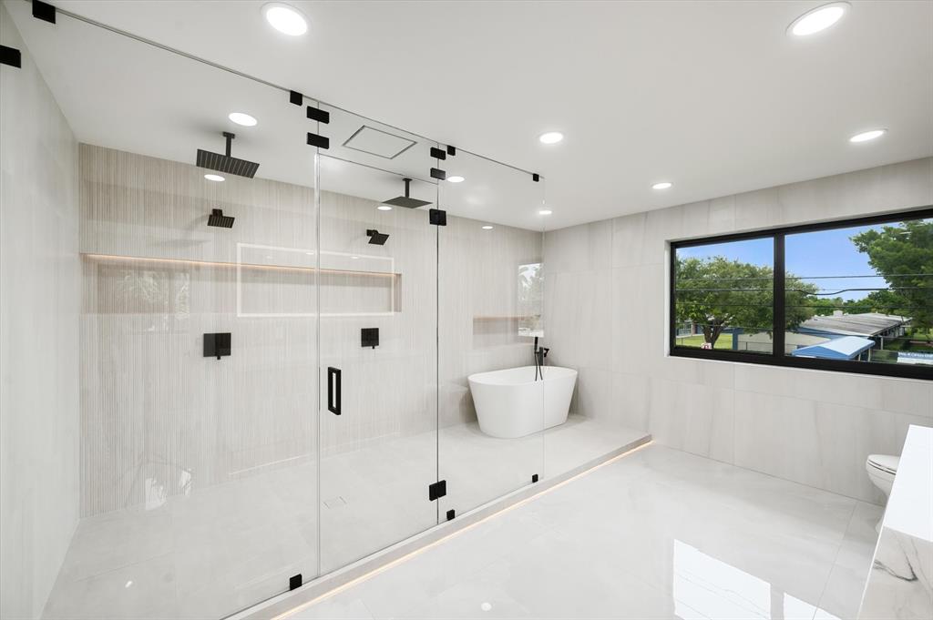 10201 Southwest 64th Street Miami, FL 33173 - Photo 25 of 50 a bathroom with a large tub and shower