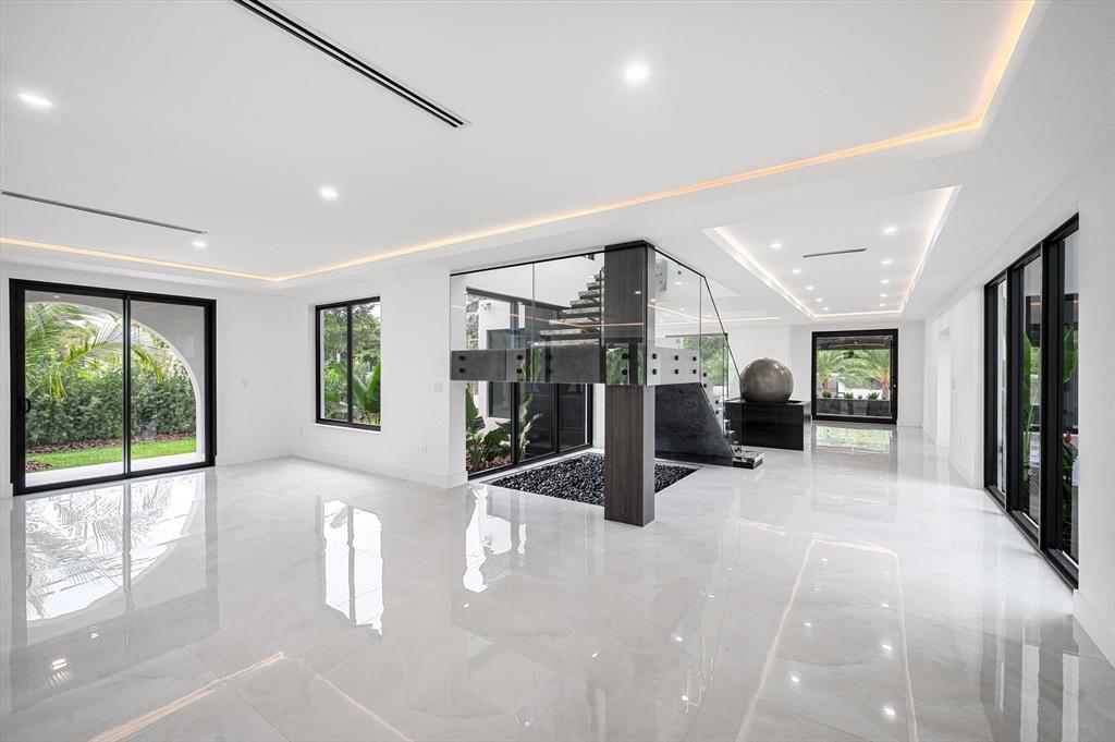 10201 Southwest 64th Street Miami, FL 33173 - Photo 8 of 50 a view of a hall with floor to ceiling windows and a livingroom