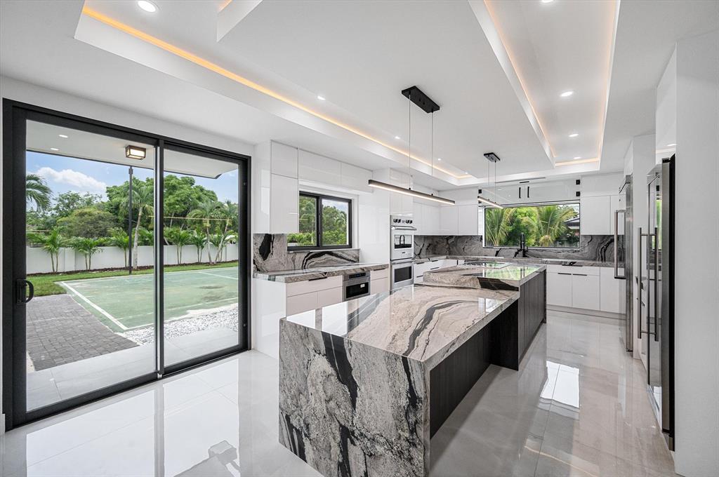 10201 Southwest 64th Street Miami, FL 33173 - Photo 9 of 50 a large white kitchen with a large window and stainless steel appliances