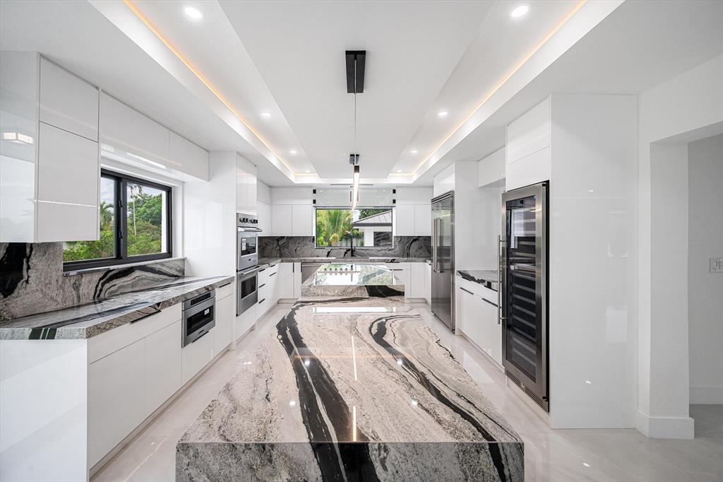 10201 Southwest 64th Street Miami, FL 33173 - Photo 10 of 50 a large white kitchen with a large window a sink and stainless steel appliances