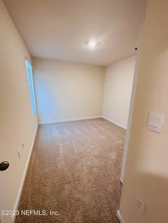 a view of an empty room and a window