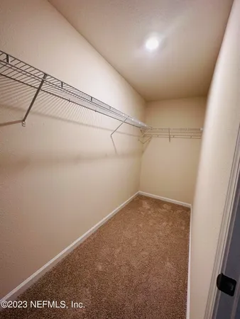 a bathroom with a double vanity sink and mirror with toilet
