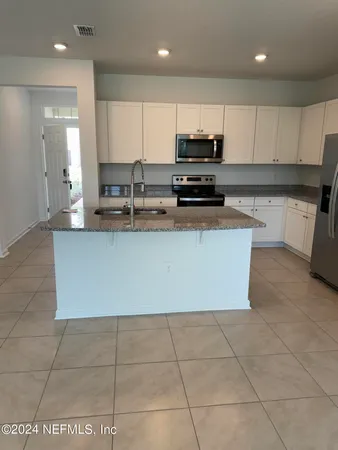 a view of a kitchen with a sink cabinets and a kitchen counter top