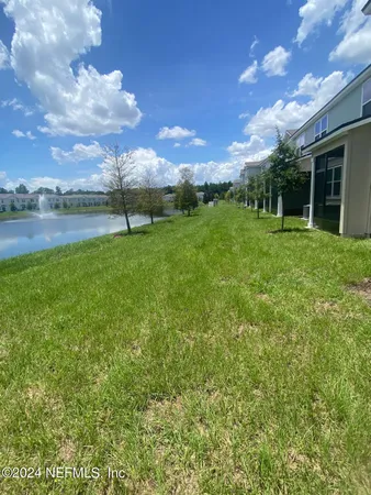 a view of a lake in middle of a town with trees all around