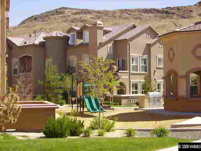 9050 Double R Boulevard, Unit 521 Reno, NV 89521 - Photo 1 of 6 a front view of a house with a yard