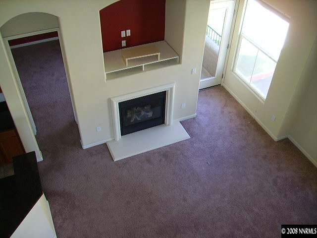 9050 Double R Boulevard, Unit 521 Reno, NV 89521 - Photo 5 of 6 a living room with furniture and a fireplace