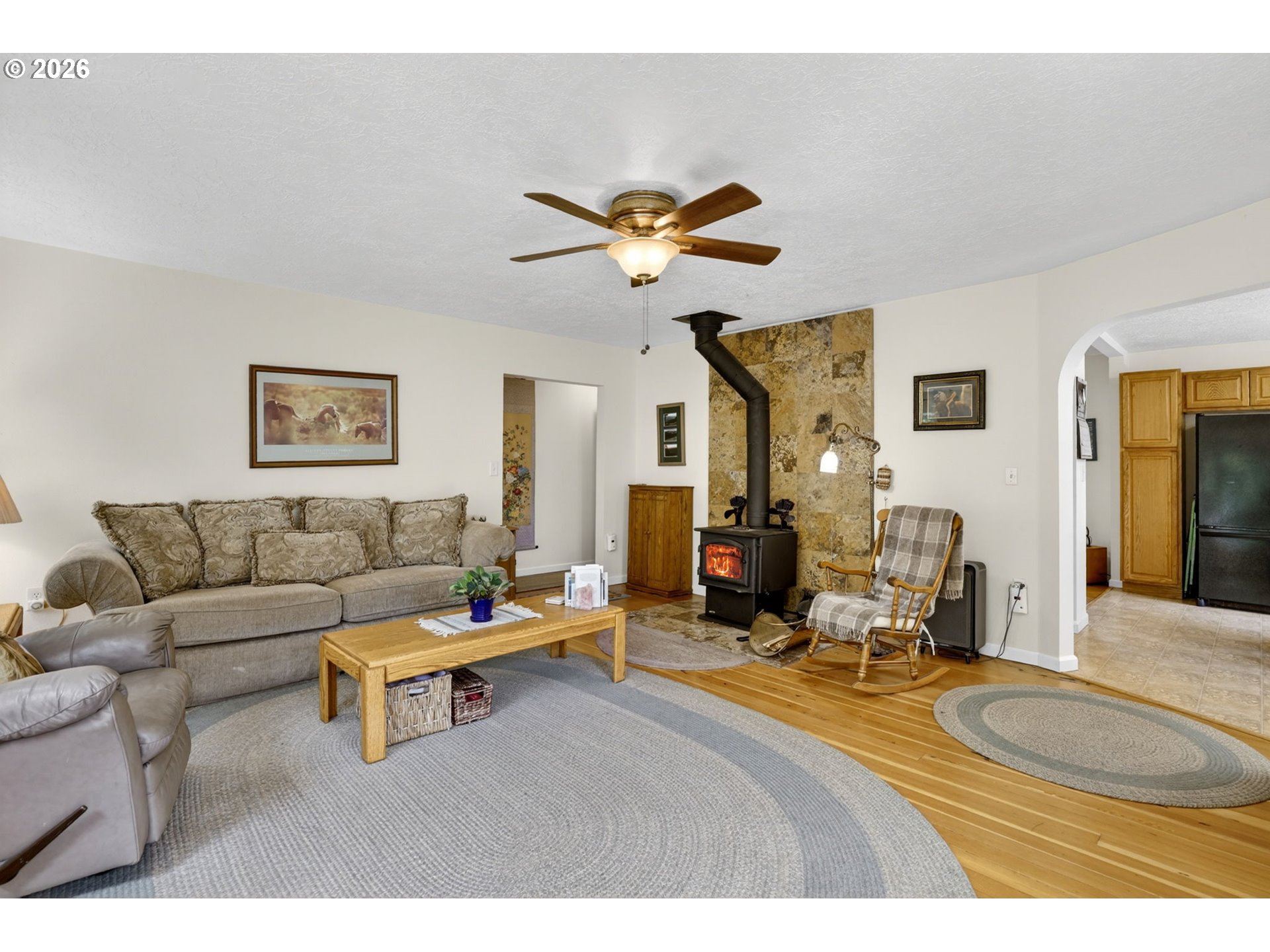 33951 Southeast Coupland Road Estacada, OR 97023 - Photo 11 of 48 a living room with furniture a fireplace and a chandelier
