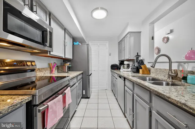 a kitchen with stainless steel appliances granite countertop a sink and stove