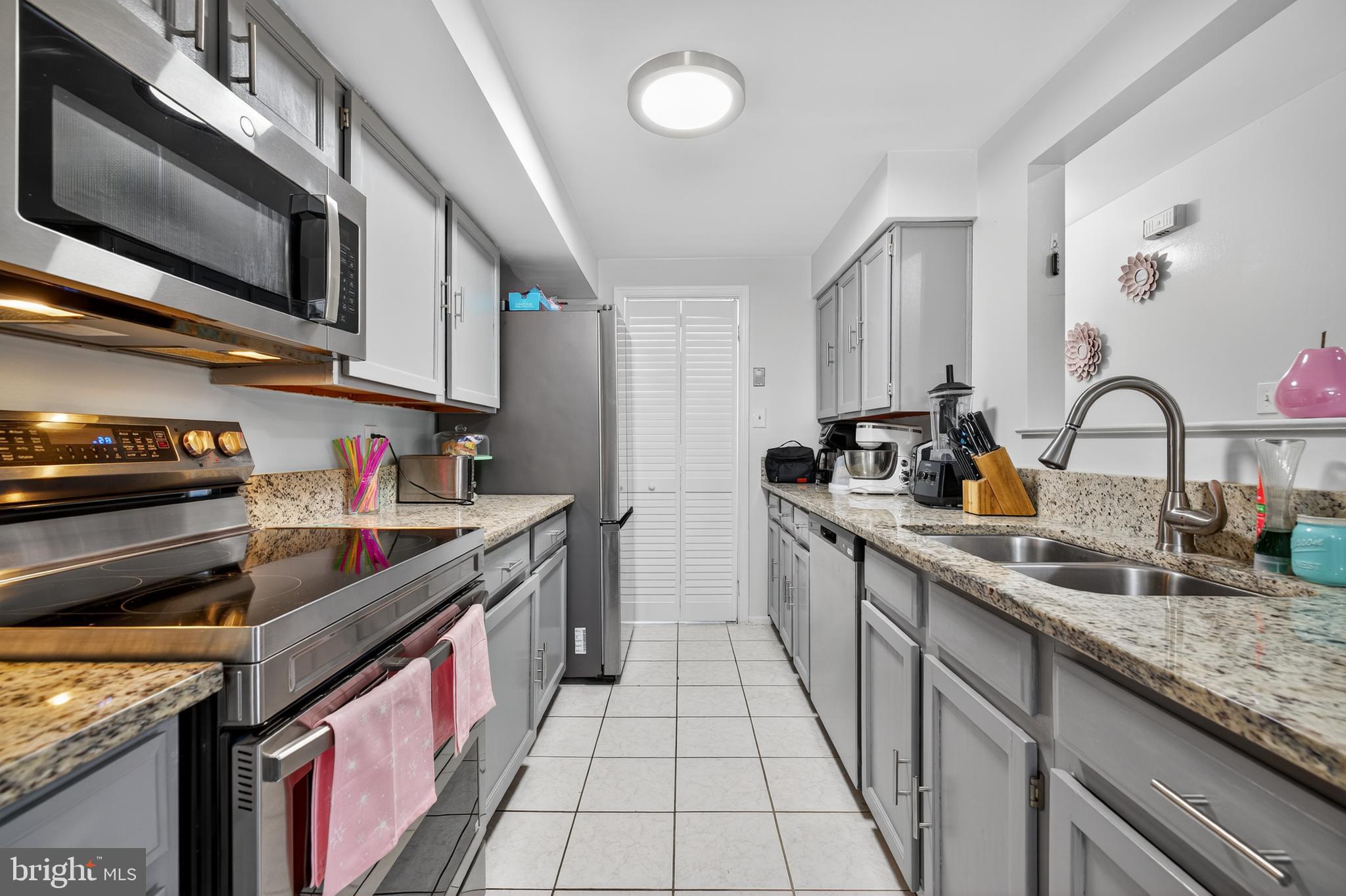 20617 Shadyside Way, Unit 997 Germantown, MD 20874 - Photo 6 of 23 a kitchen with stainless steel appliances granite countertop a sink and stove