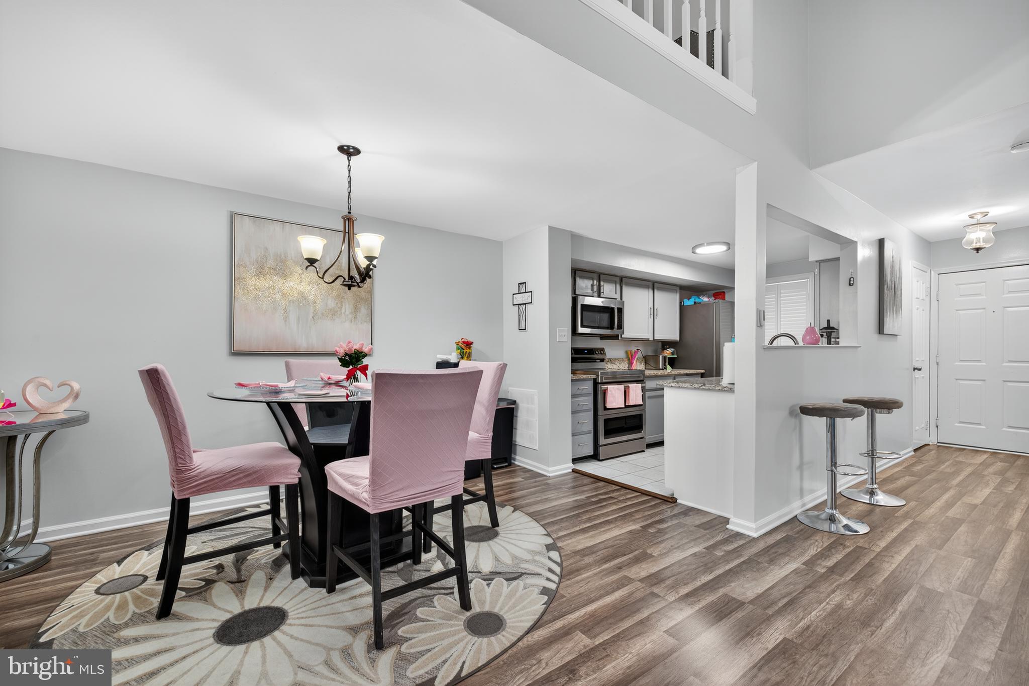 20617 Shadyside Way, Unit 997 Germantown, MD 20874 - Photo 7 of 23 a view of a dining room with furniture and wooden floor
