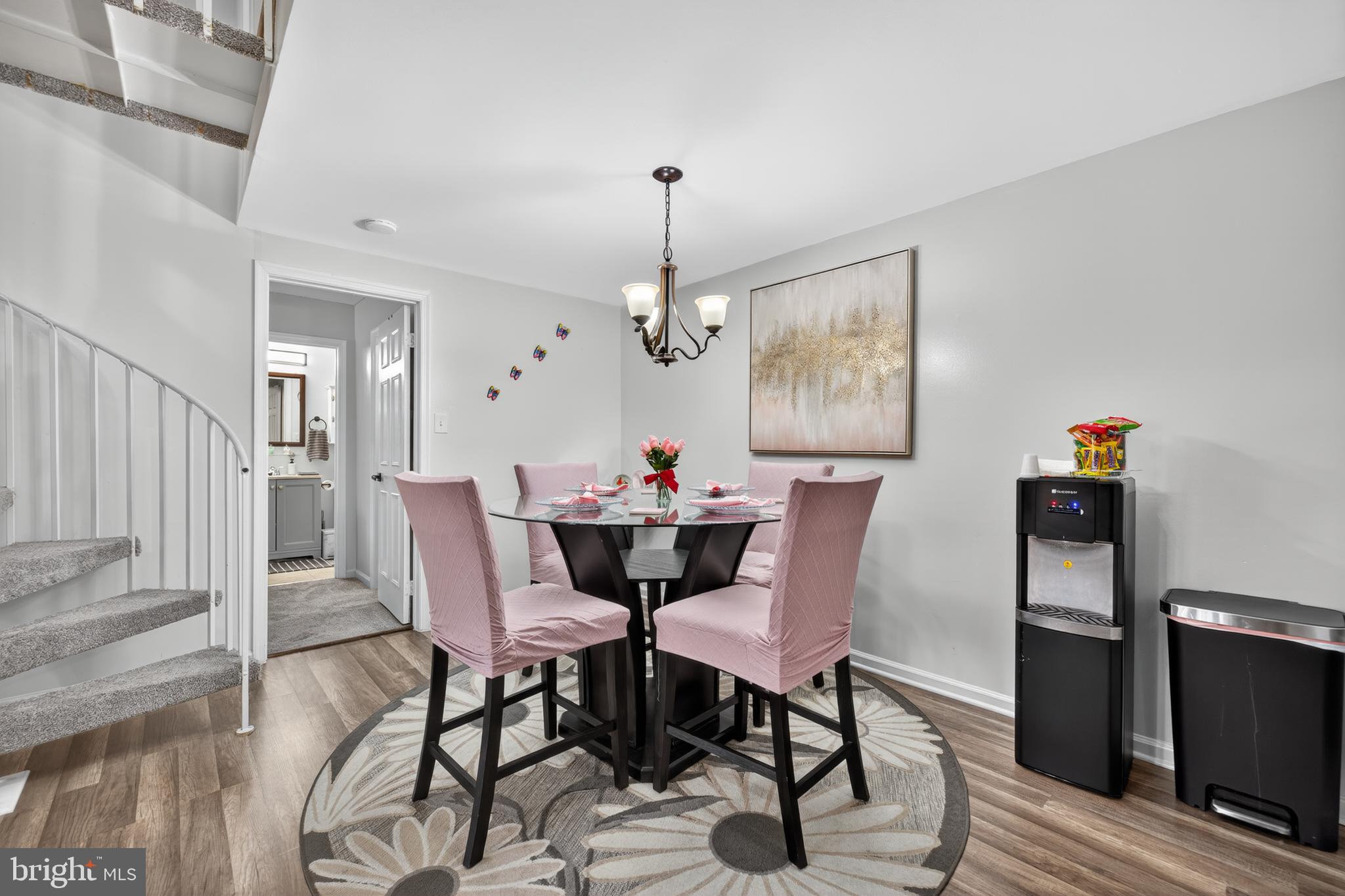 20617 Shadyside Way, Unit 997 Germantown, MD 20874 - Photo 8 of 23 a dining room with furniture a chandelier and wooden floor
