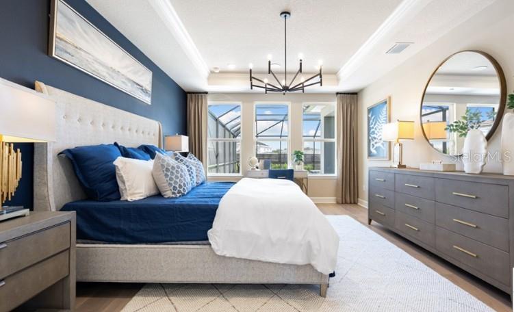 11270 Kingly Lane Odessa, FL 33556 - Photo 6 of 19 a spacious bedroom with a bed and wooden floor