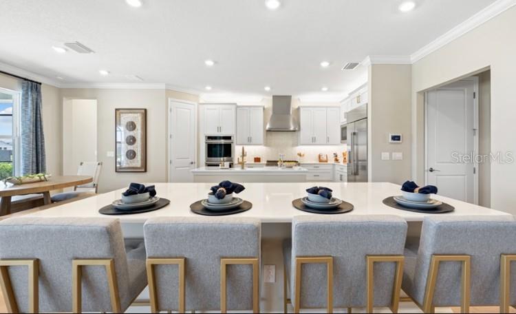 11270 Kingly Lane Odessa, FL 33556 - Photo 7 of 19 a kitchen with stainless steel appliances a stove a sink and a refrigerator