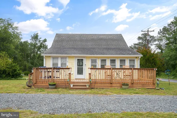 a front view of a house with a yard table and chairs
