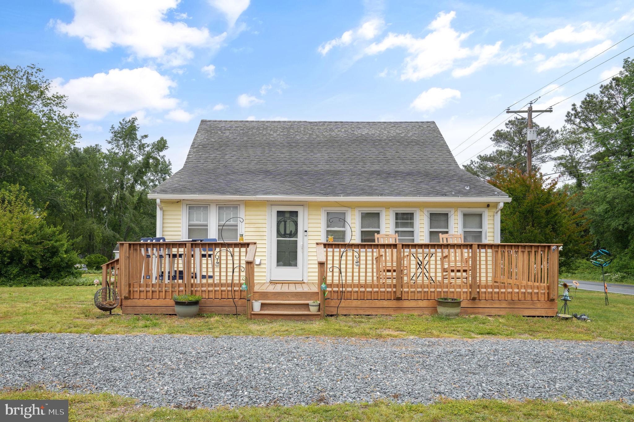 a front view of a house with a yard table and chairs