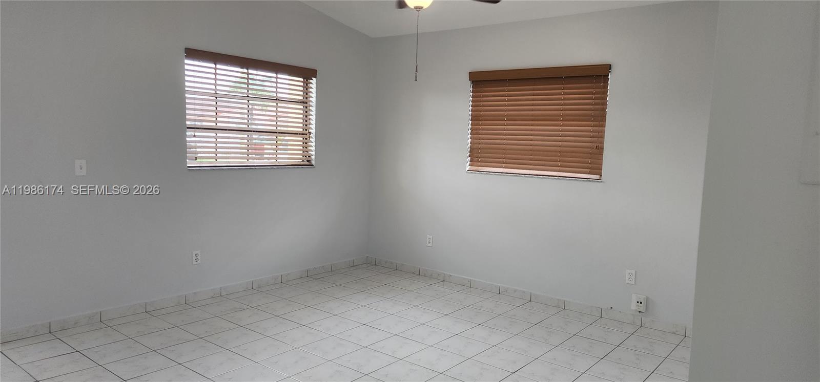 2574 West 71st Place Hialeah, FL 33016 - Photo 12 of 17 an empty room with windows