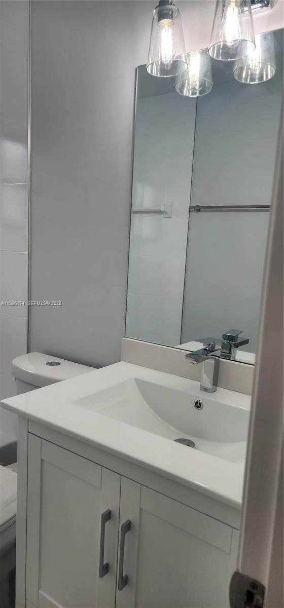 2574 West 71st Place Hialeah, FL 33016 - Photo 10 of 17 a bathroom with a sink and a mirror