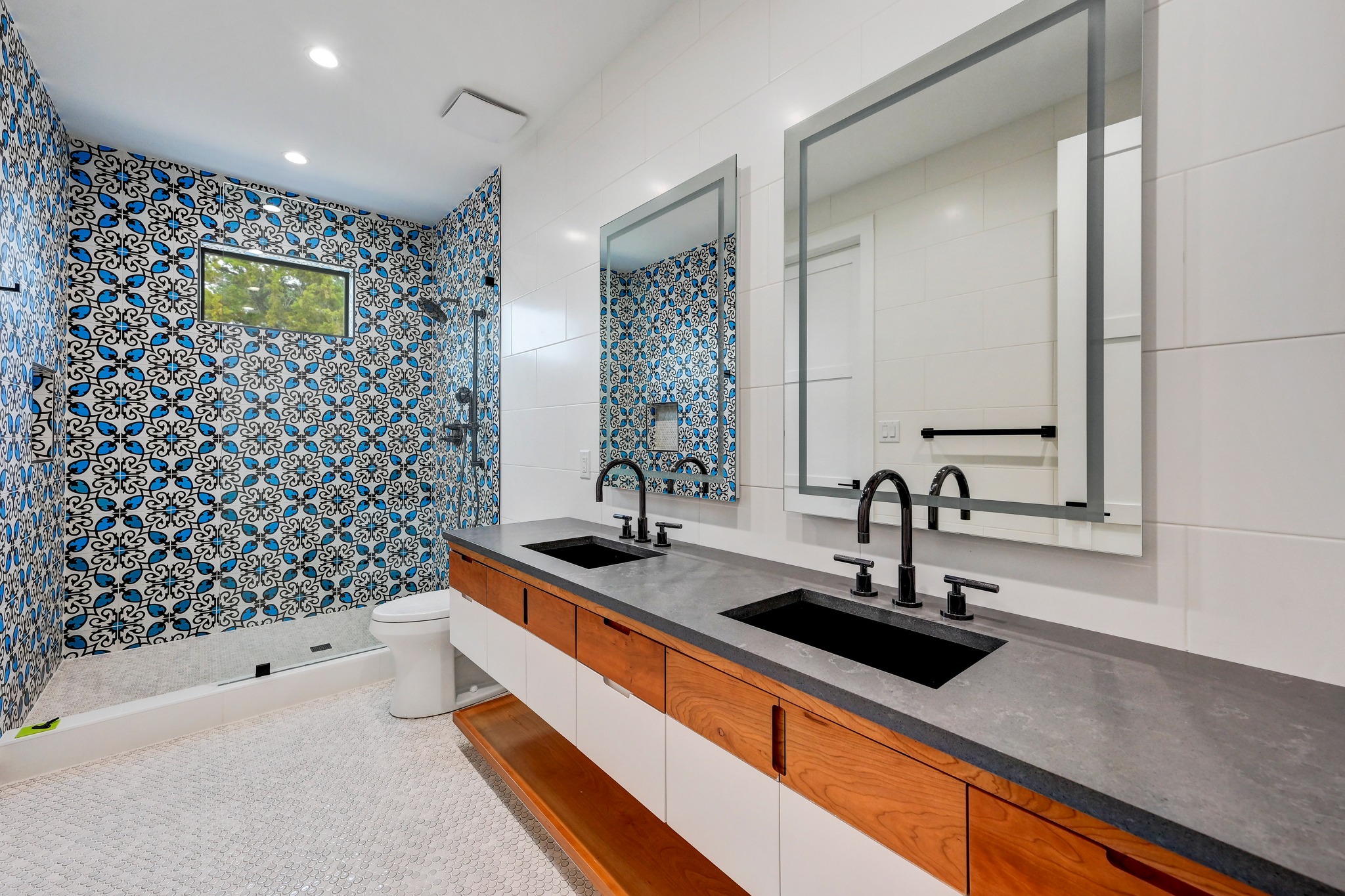 700 Rancho Grande Drive Wimberley, TX 78676 - Photo 17 of 39 Full bathroom featuring double vanity, a shower stall, tile walls, and recessed lighting
