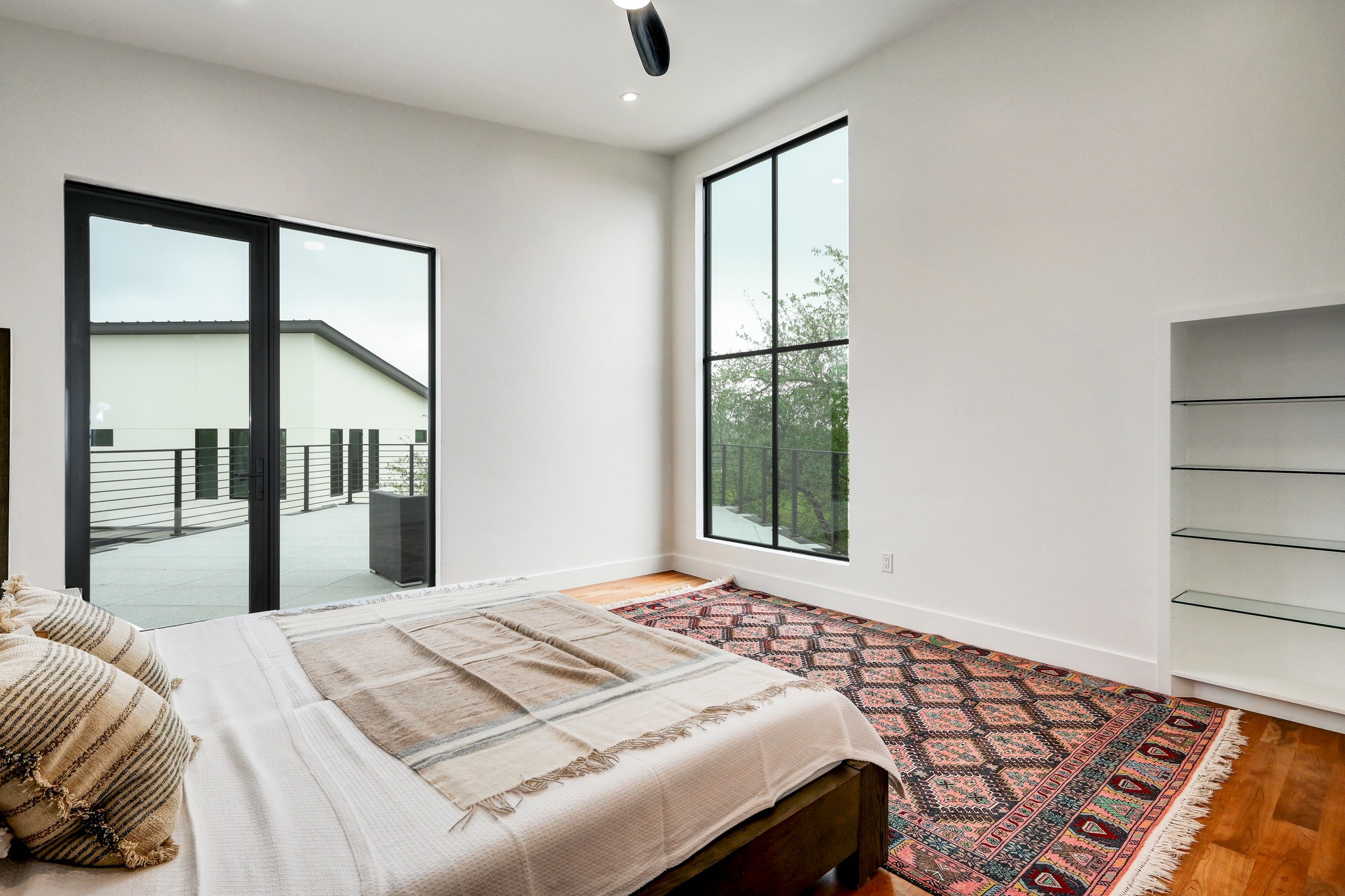 700 Rancho Grande Drive Wimberley, TX 78676 - Photo 22 of 39 Upstairs second primary bedroom with access to large outside veranda with amazing views