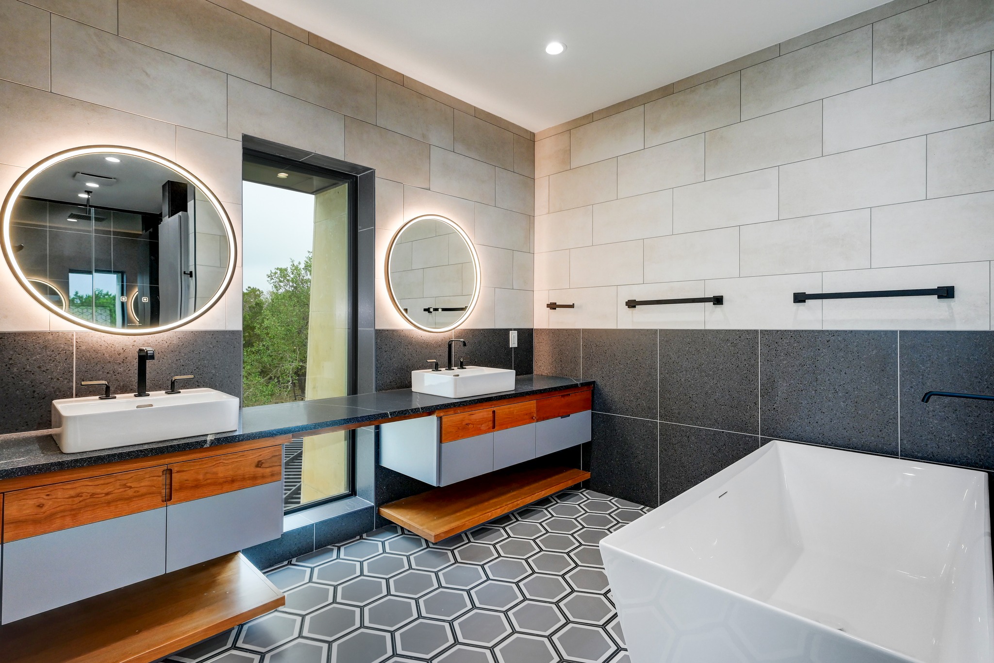 700 Rancho Grande Drive Wimberley, TX 78676 - Photo 23 of 39 Bathroom featuring tile walls, a soaking tub, double vanity, recessed lighting, tile floors
