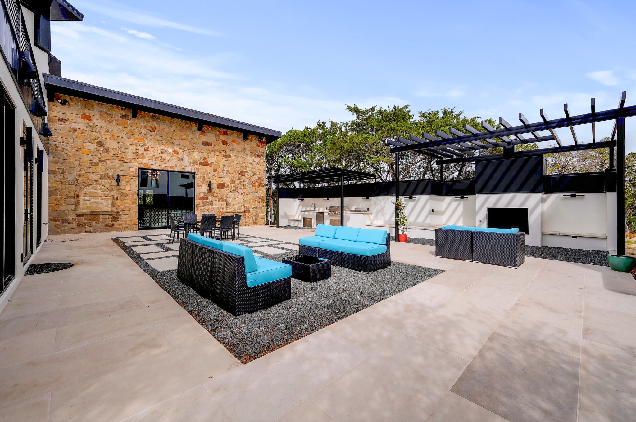 700 Rancho Grande Drive Wimberley, TX 78676 - Photo 35 of 39 View of patio / terrace featuring a pergola, a fireplace, outdoor kitchen and an outdoor living / dining area